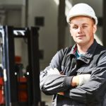 Young,Smiling,Warehouse,Worker,Driver,In,Uniform,In,Front,Of