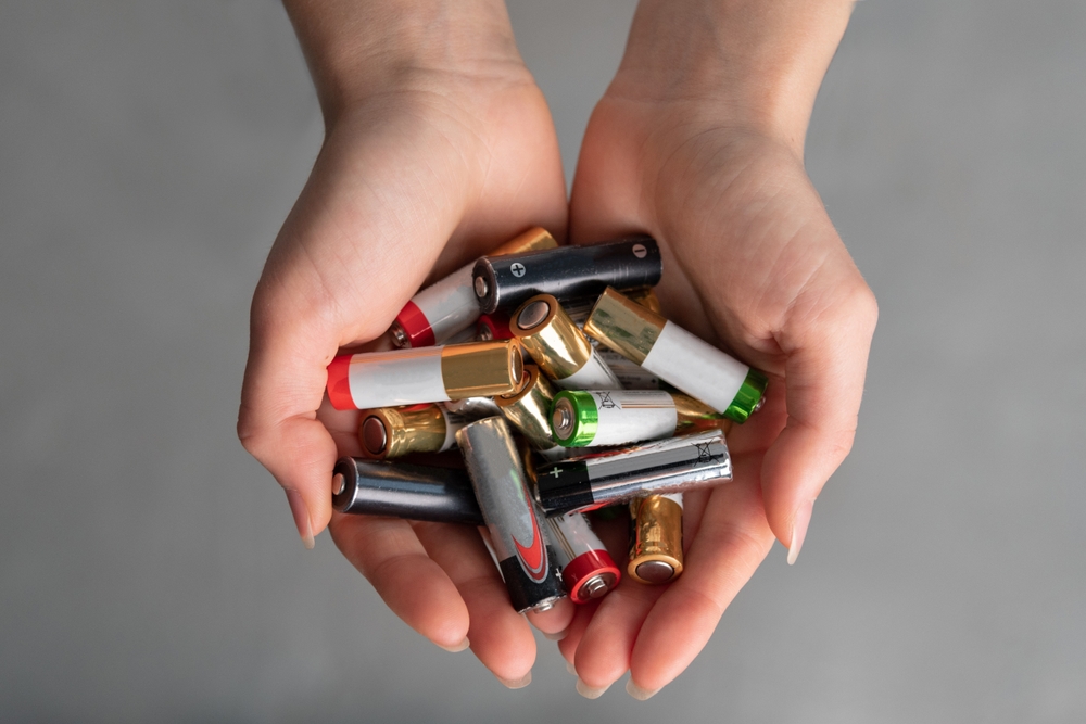 Top,View,View,Of,Hands,Full,Of,Alkaline,Batteries,,Hands